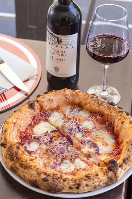 Florence: Private Pizza Making Class with Wine Tasting - Adding sauce and preparing your pizza
