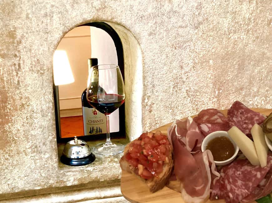 Florence: Wine Windows Walk with Wine Tasting and Appetizers - The first pour at a Renaissance wine window
