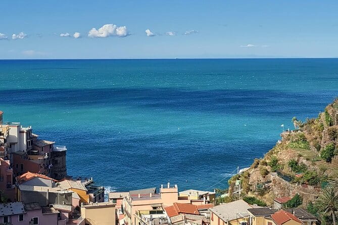Small Group Day Tour in Cinque Terre and Pisa From Florence - Riomaggiore’s cliffs, castle, and pebble beach